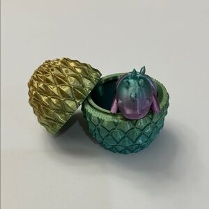 Yellow and teal dragon egg with baby dragon inside.